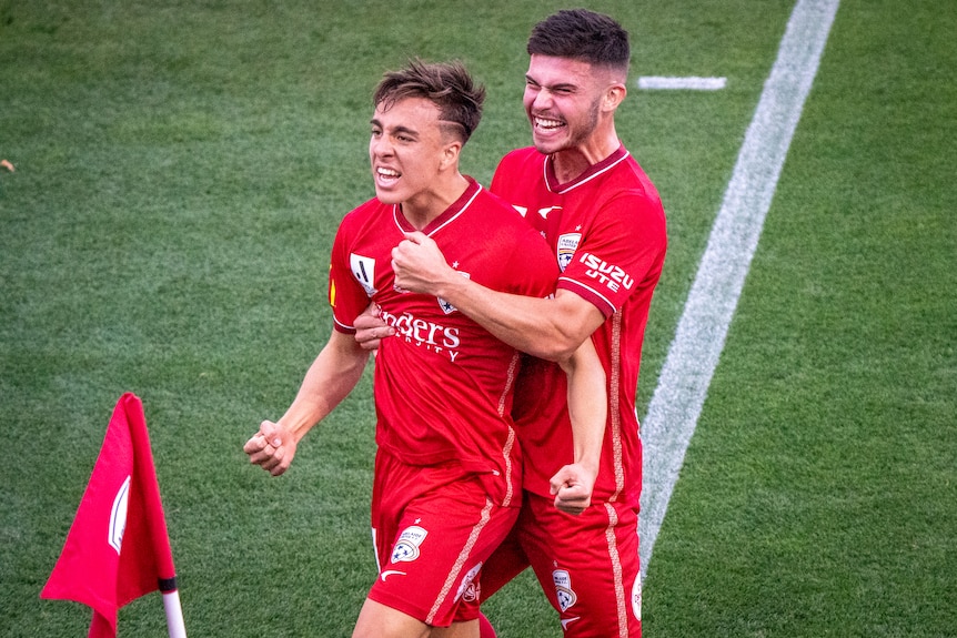 Adelaide United's Bernardo and Alex Popovic embrace each other