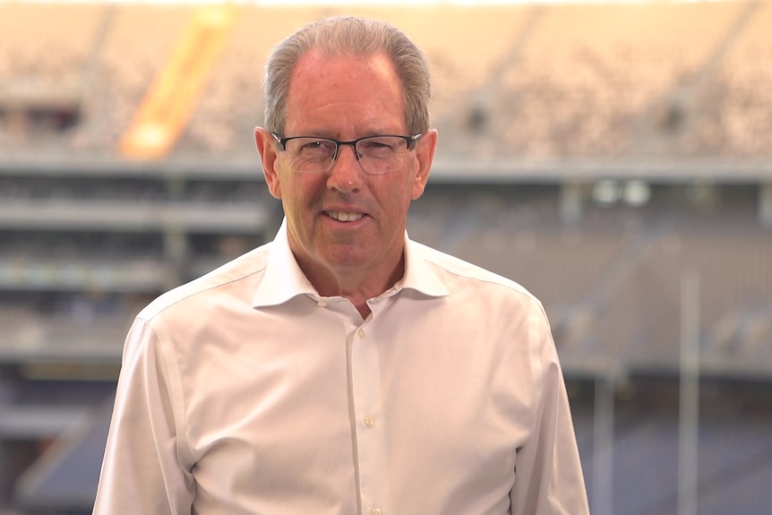 A man in a white shirt and glasses. 
