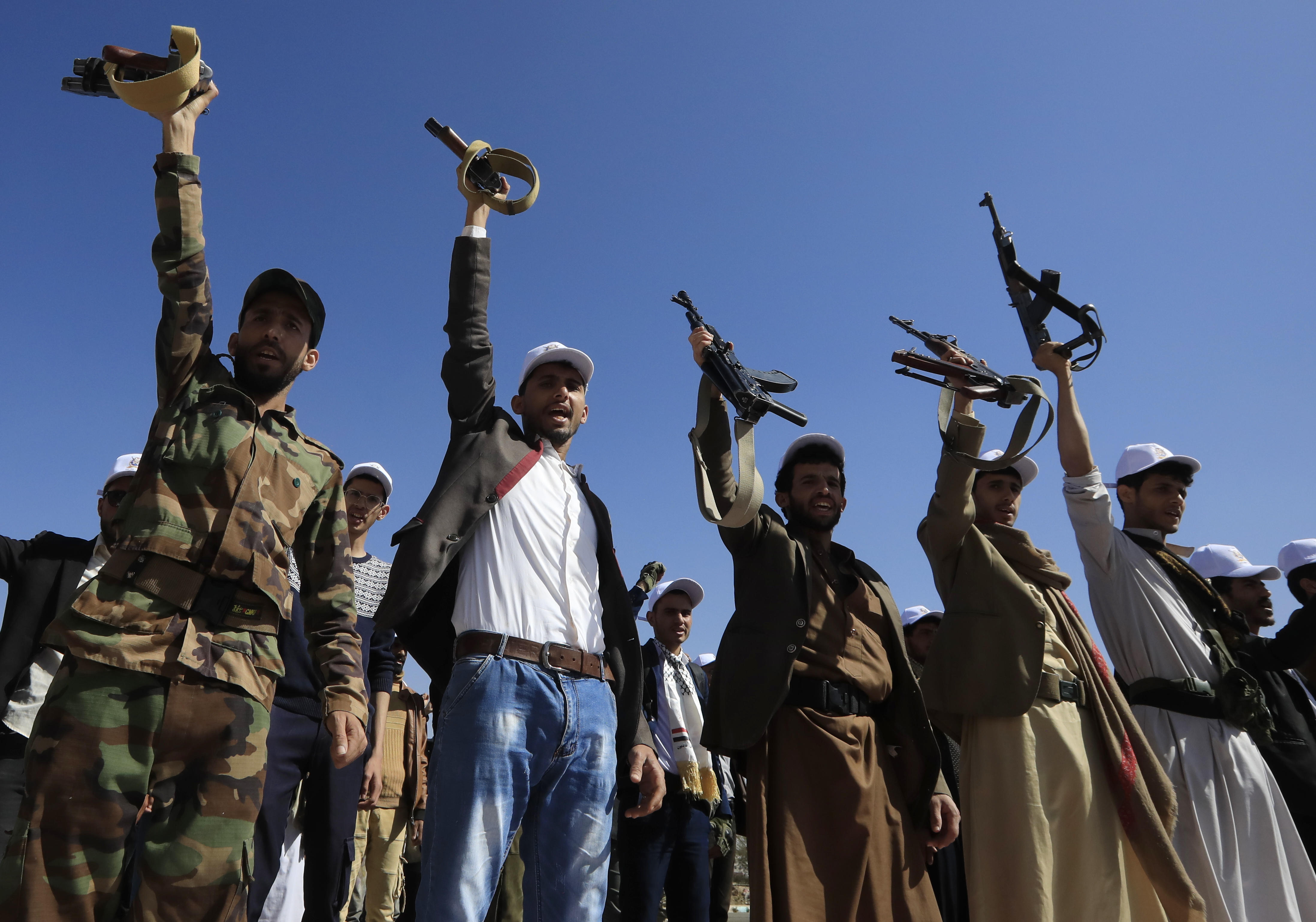 Newly recruited university students shout slogans during a protest against US-led strikes on Houthi positions, at Sana'a University, in Yemen in February 2024