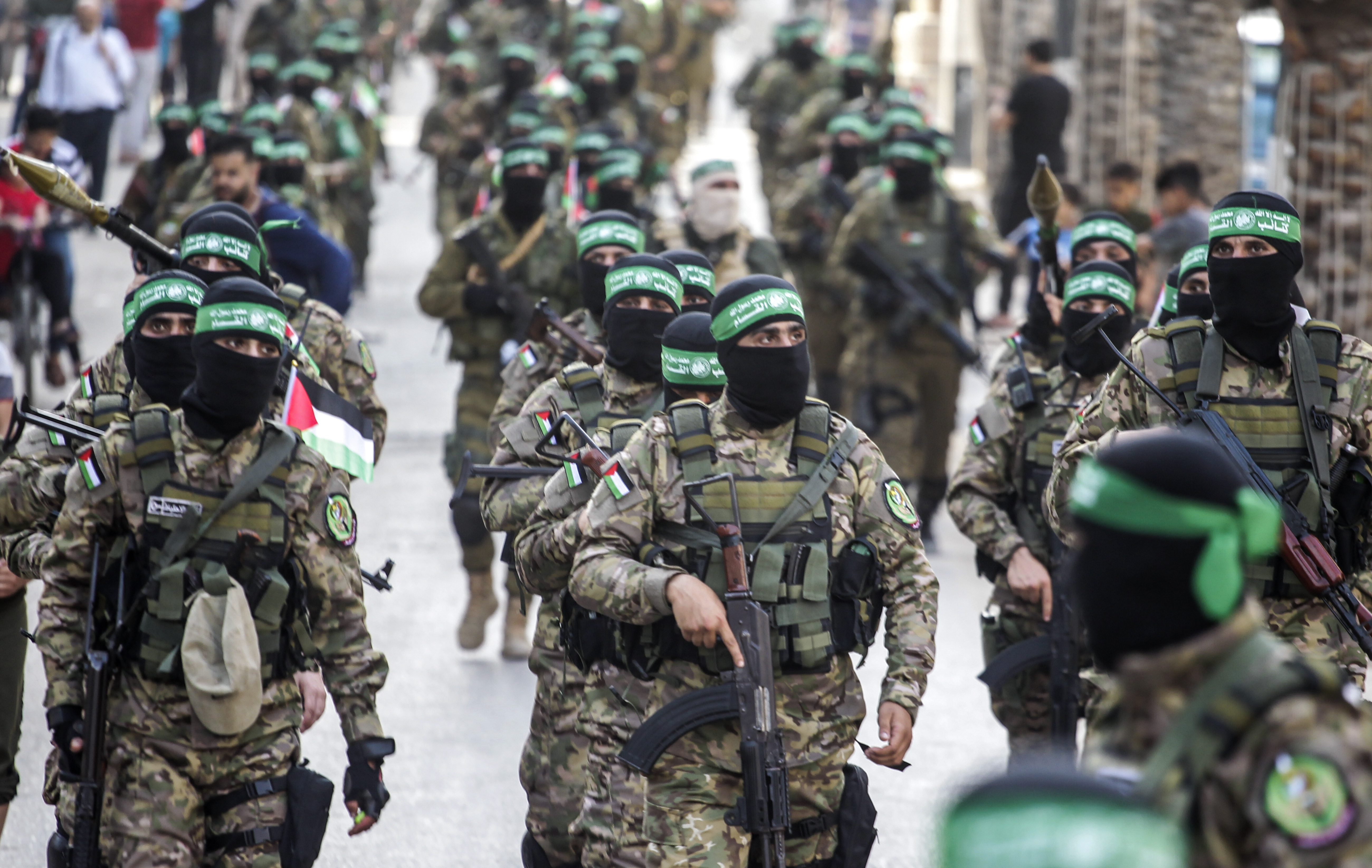 Members of the Ezz-Aldine Al-Qassam Brigades, a military wing of Hamas, marching with their guns in the streets of Nuseirat refugee camp, central Gaza Strip in 2021