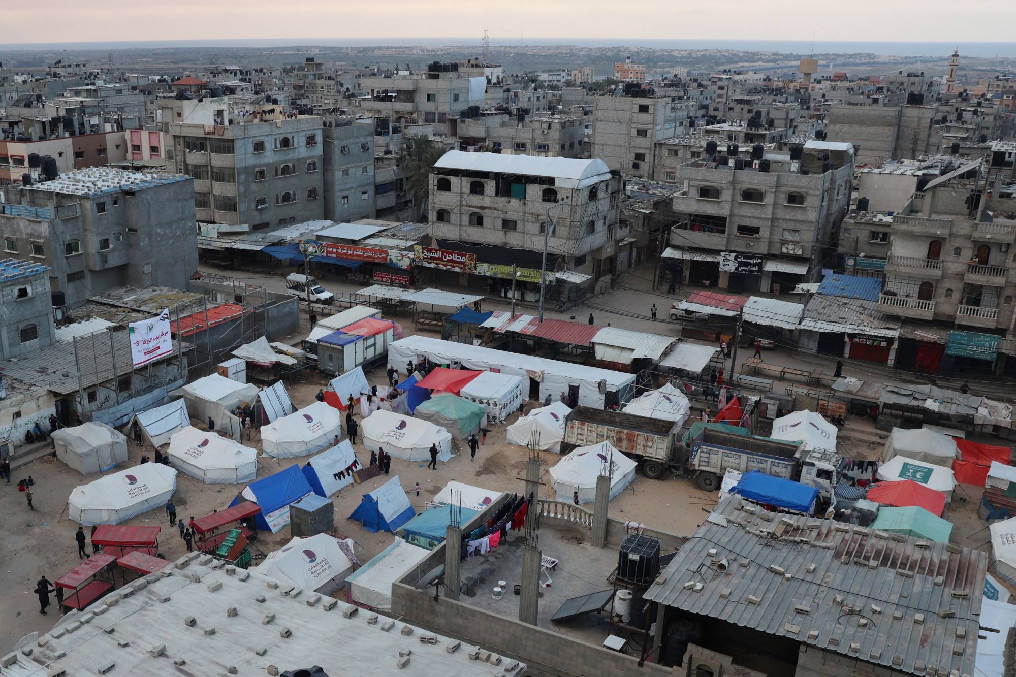 Displaced Palestinians stand outside their tents in Rafah in the southern Gaza Strip on Wednesday. Photo: AFP