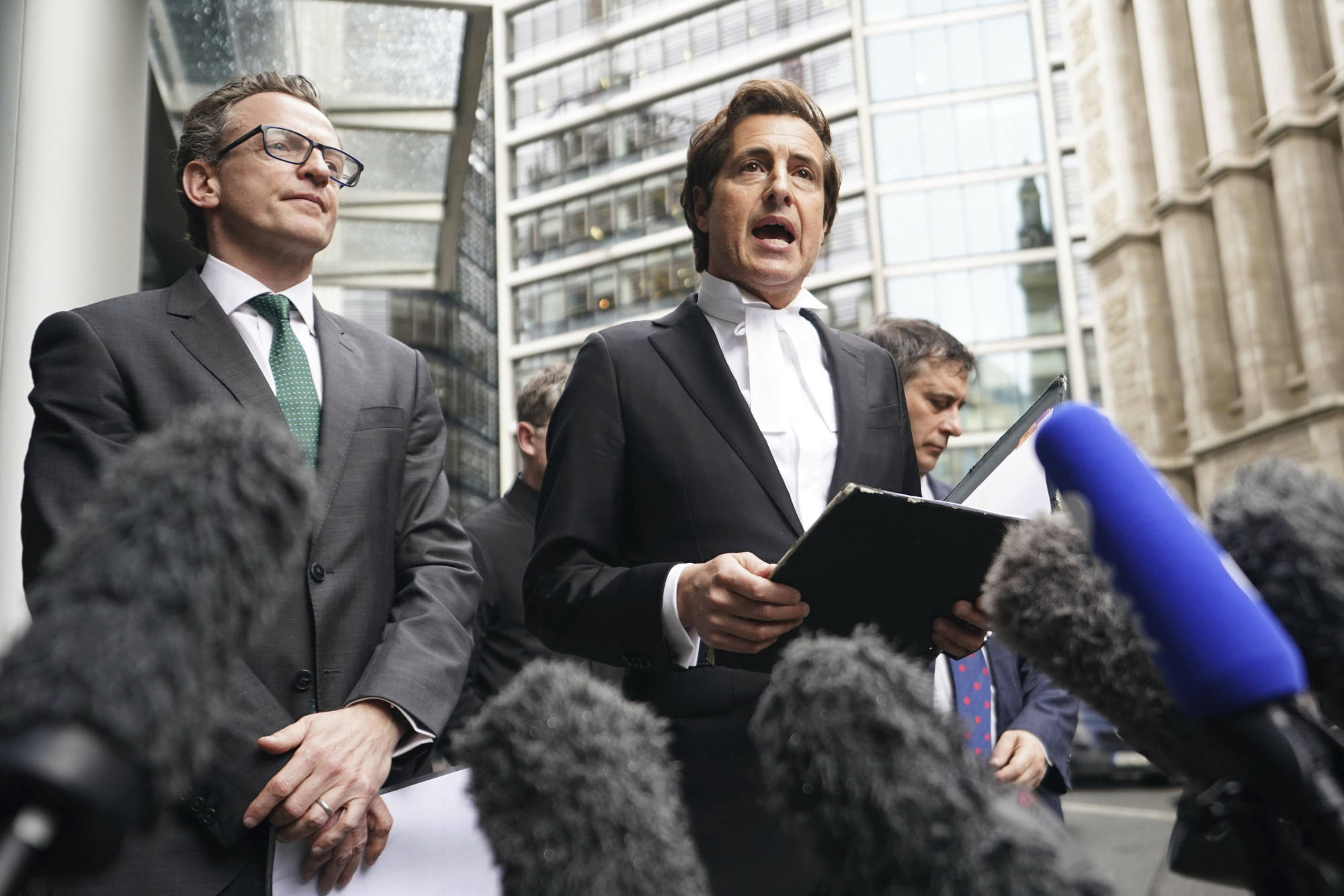 Prince Harry’s lawyer, David Sherborne (right), speaks to the media outside the Rolls Building in London on Friday. Photo: PA via AP