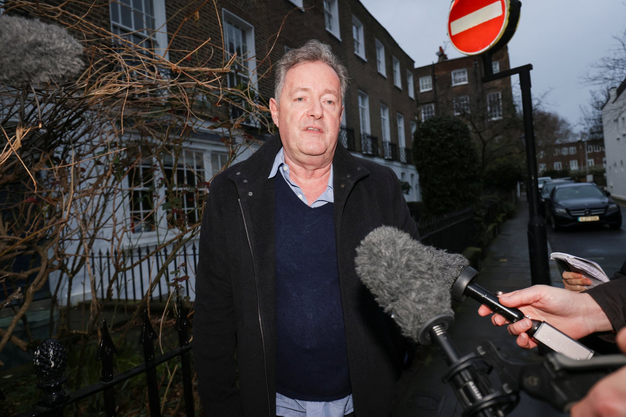 Former Daily Mirror editor Piers Morgan speaks to the media on his way back home in London on Friday. Photo: Reuters
