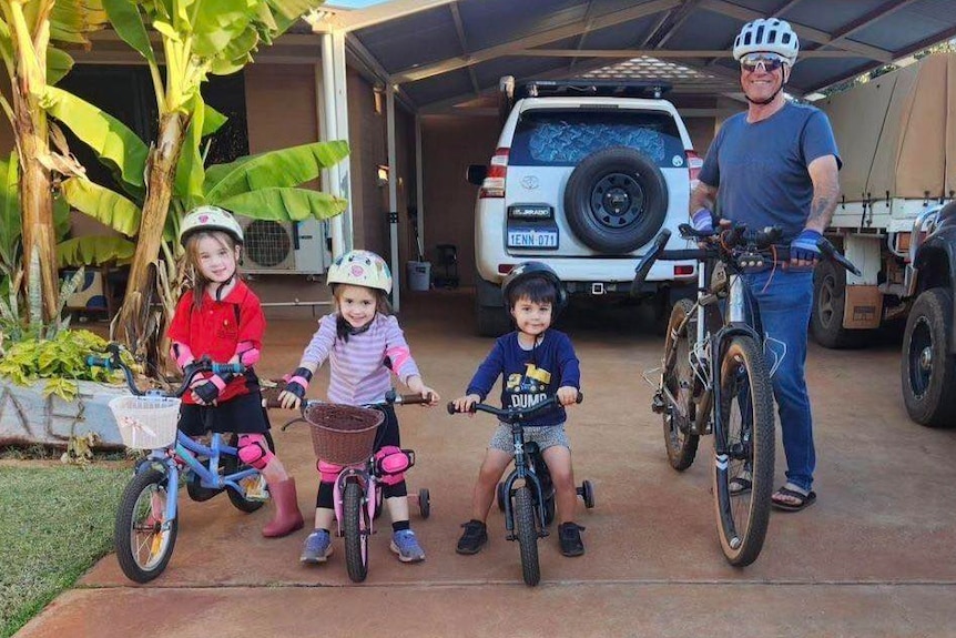 The four each stand with a bike