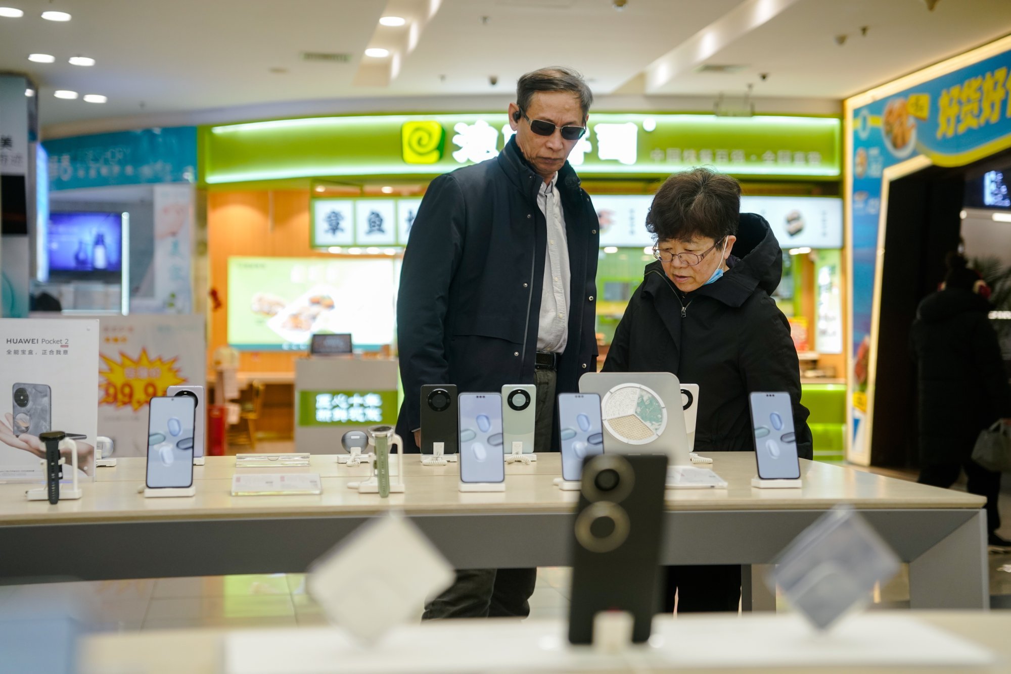 Customers browse a Huawei store in Beijing. Photo: EPA-EFE