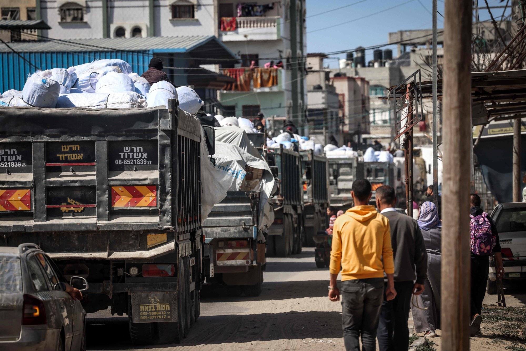 Trucks carrying humanitarian aid make their way along a street in Rafah in the southern Gaza Strip on Sunday. Photo: AFP
