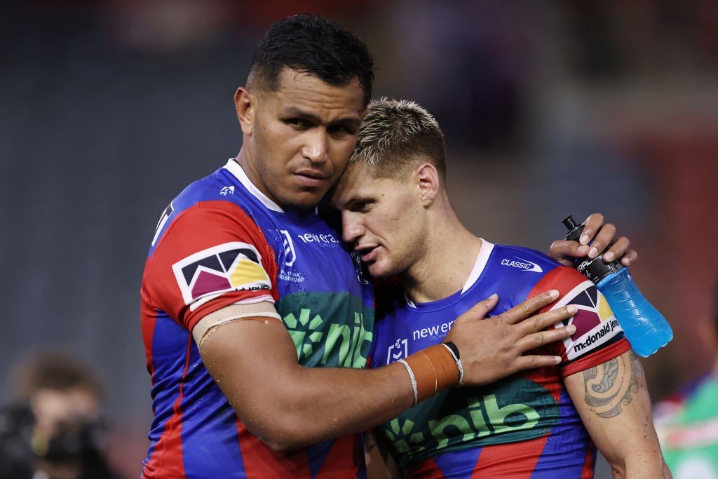 Jacob Saifiti hugs Newcastle Knights teammate Kalyn Ponga after an NRL loss.
