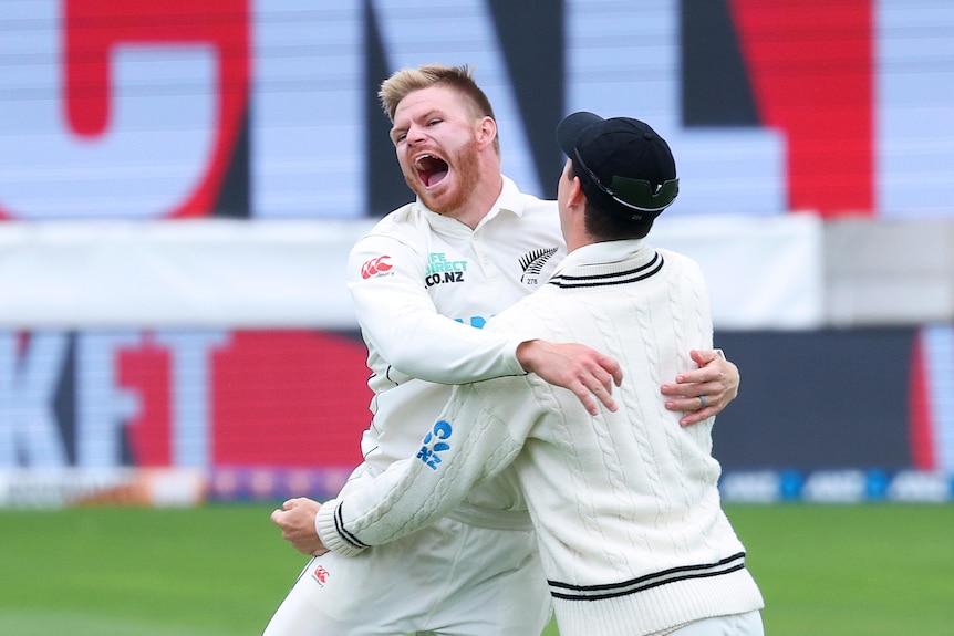 Glenn Phillips leaps into the arms of a teammate