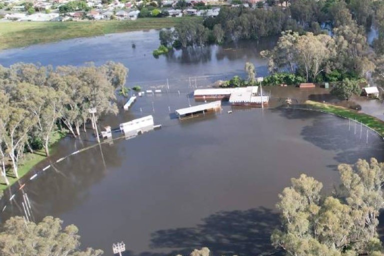 A country football ground from the air. it is underwater, and the buildings around it submerged