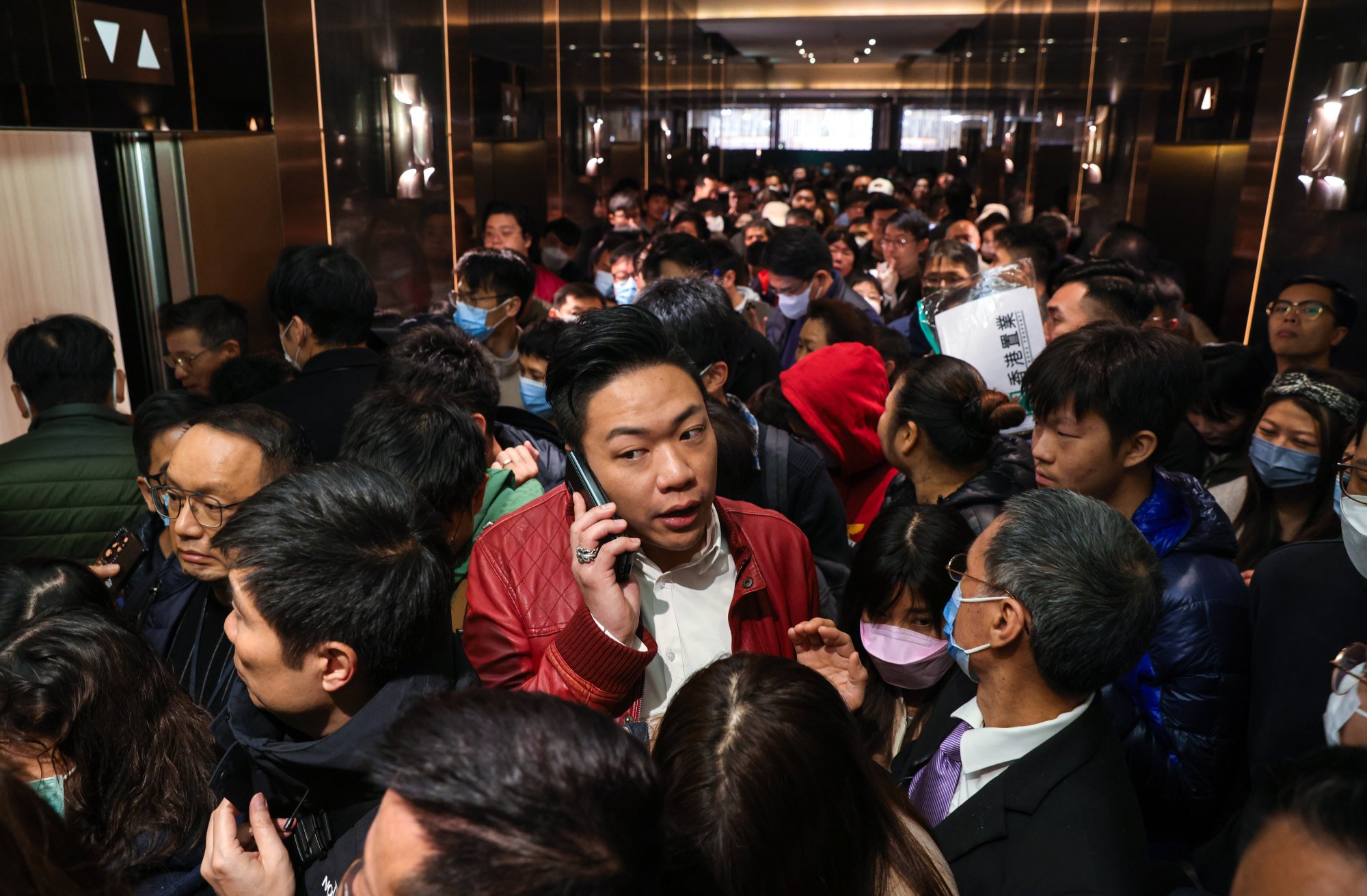 Potential homebuyers line up for Henderson Land’s Belgravia Place project in Hong Kong’s Tsim Sha Tsui on Sunday. Photo: Yik Yeung-man