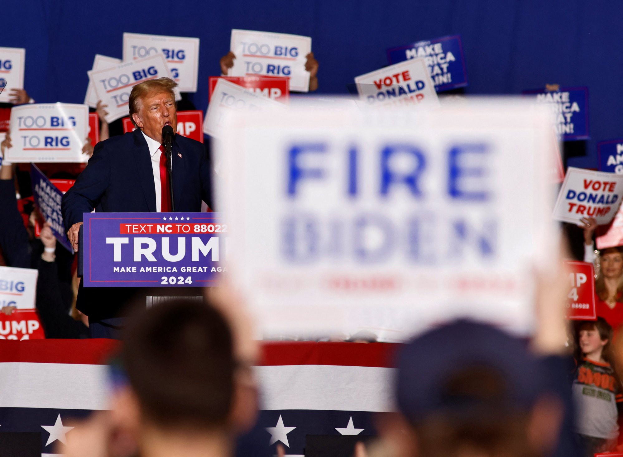 A supporter of Republican presidential candidate Donald Trump displays a sign calling for the firing of US President Joe Biden at Trump’s rally in Greensboro, North Carolina, on Saturday. Photo: Reuters