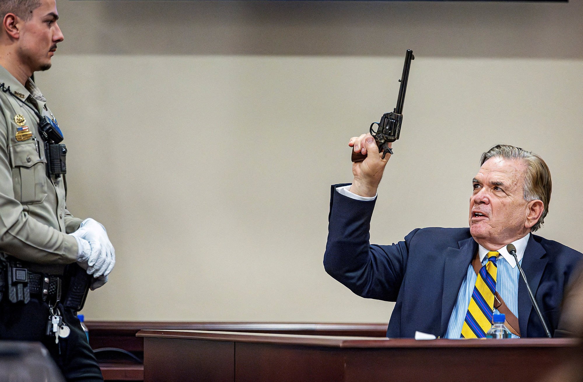 Defence witness Frank Koucky (right) shows how to handle a gun like the one used on the Rust set at the First Judicial District Courthouse in Santa Fe, New Mexico, on Tuesday. Photo: Reuters