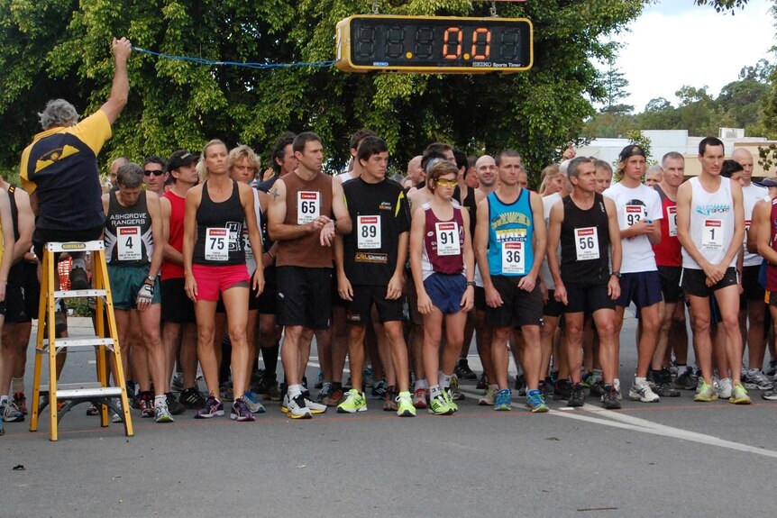 Runners line up at the starting line waiting to run.