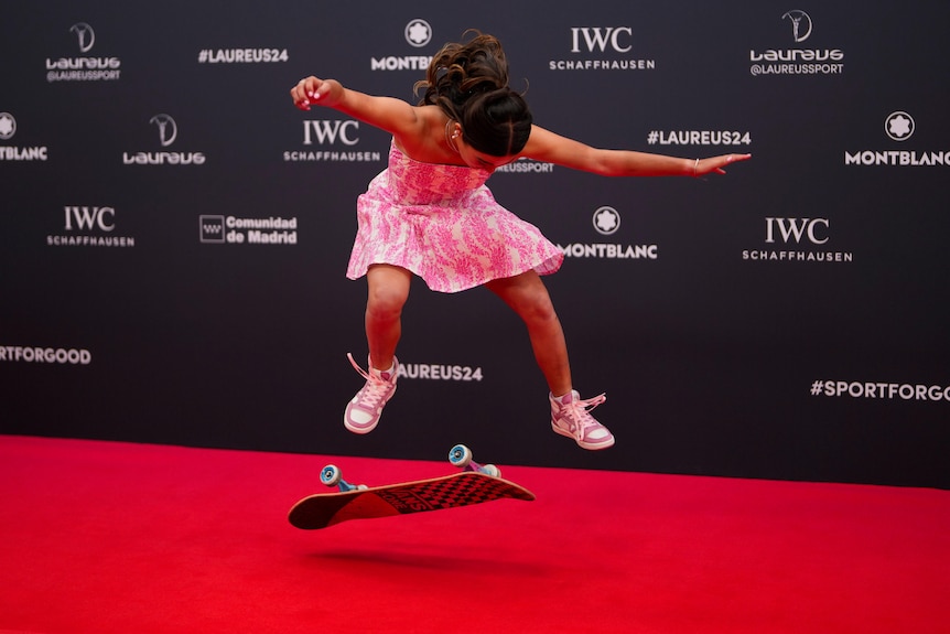 Arisa Trew photographed in mid-air above her skateboard while doing a trick on the red carpet at the Laureus sport awards.