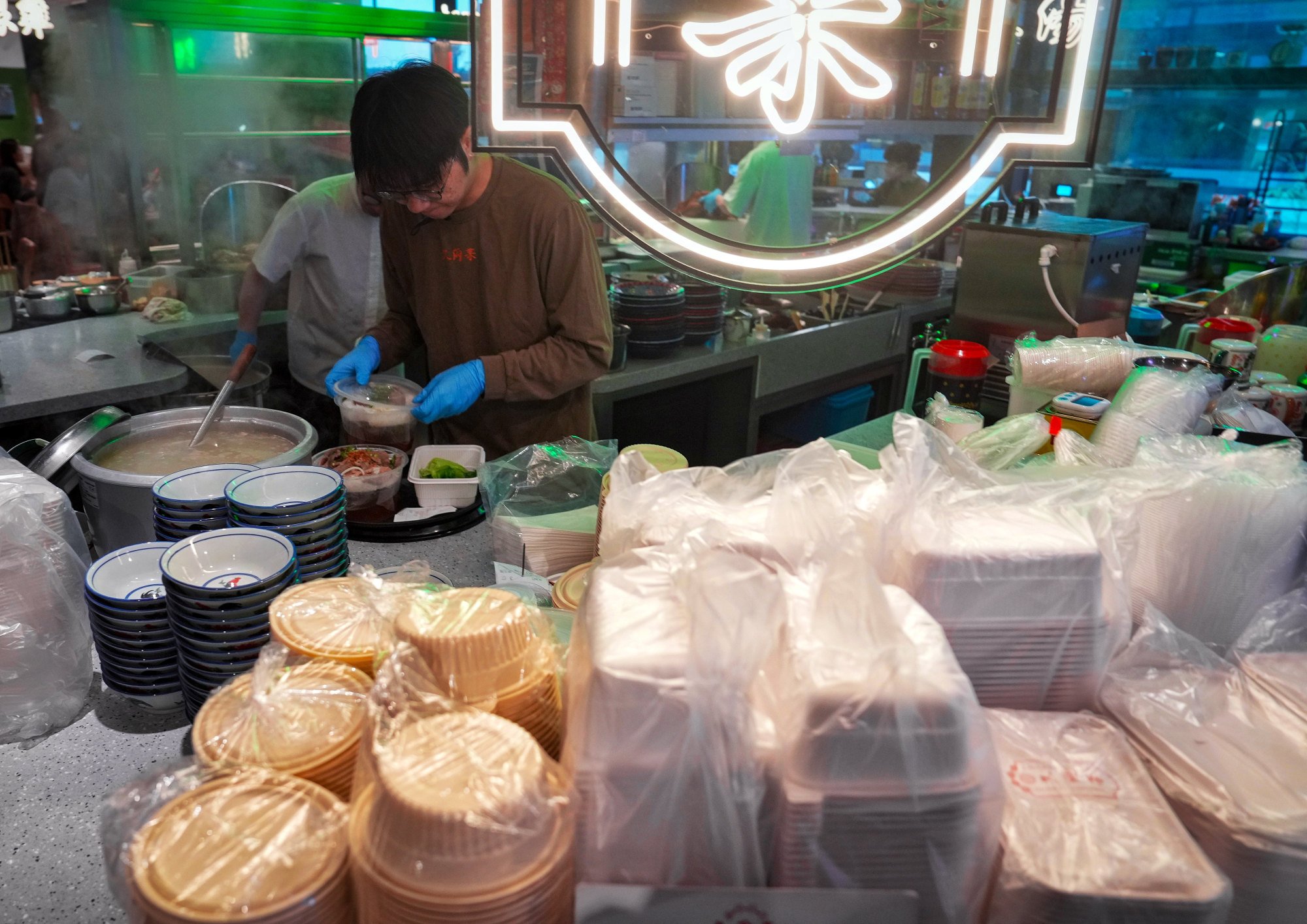 Restaurant staff use eco-friendly utensils to pack takeaway food for customers. Photo: Elson Li