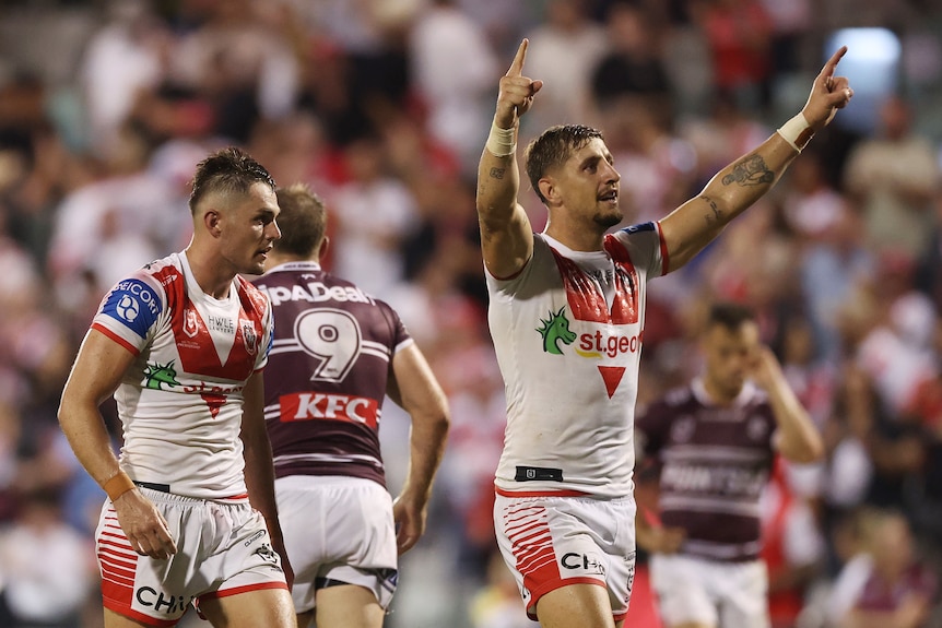 A man celebrates after his team won a rugby league match