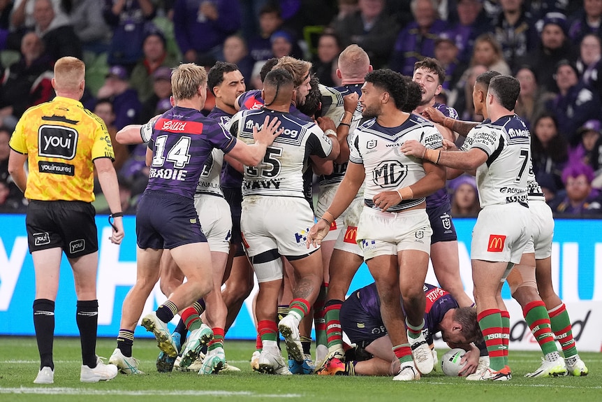 Melbourne Storm and South Sydney Rabbitohs players tussle after Taane Milne's ugly tackle on Cameron Munster.