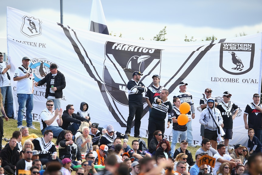 A group of rugby league fans watch their team play 