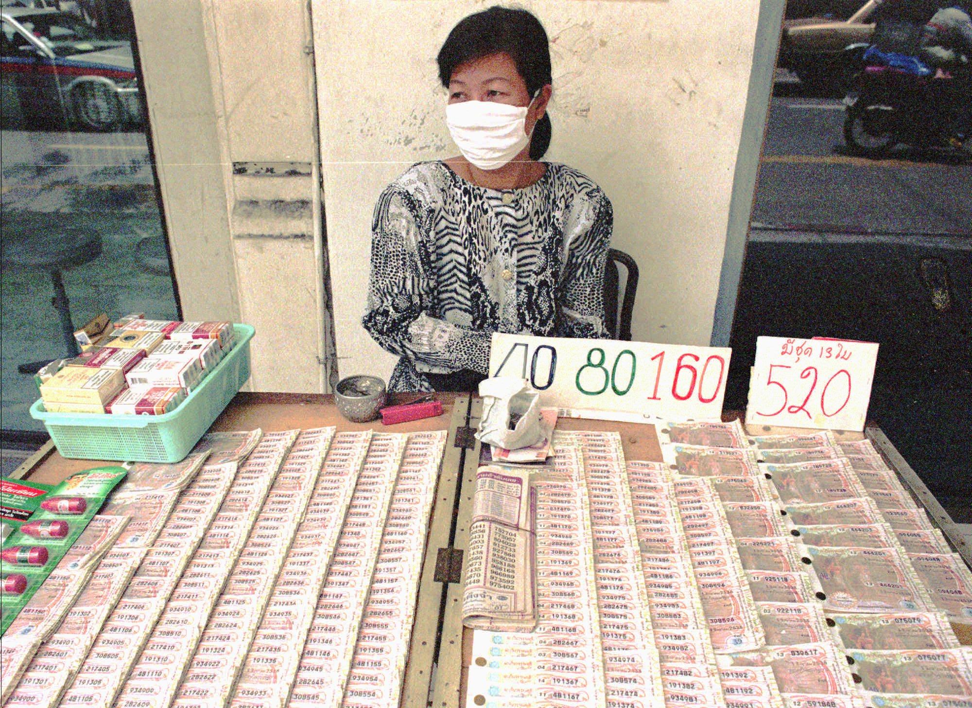 A Thai woman sells lottery tickets on a Bangkok street in this file photo from 1995. Thailand’s existing gambling laws ban all but state-sanctioned betting. Photo: AP