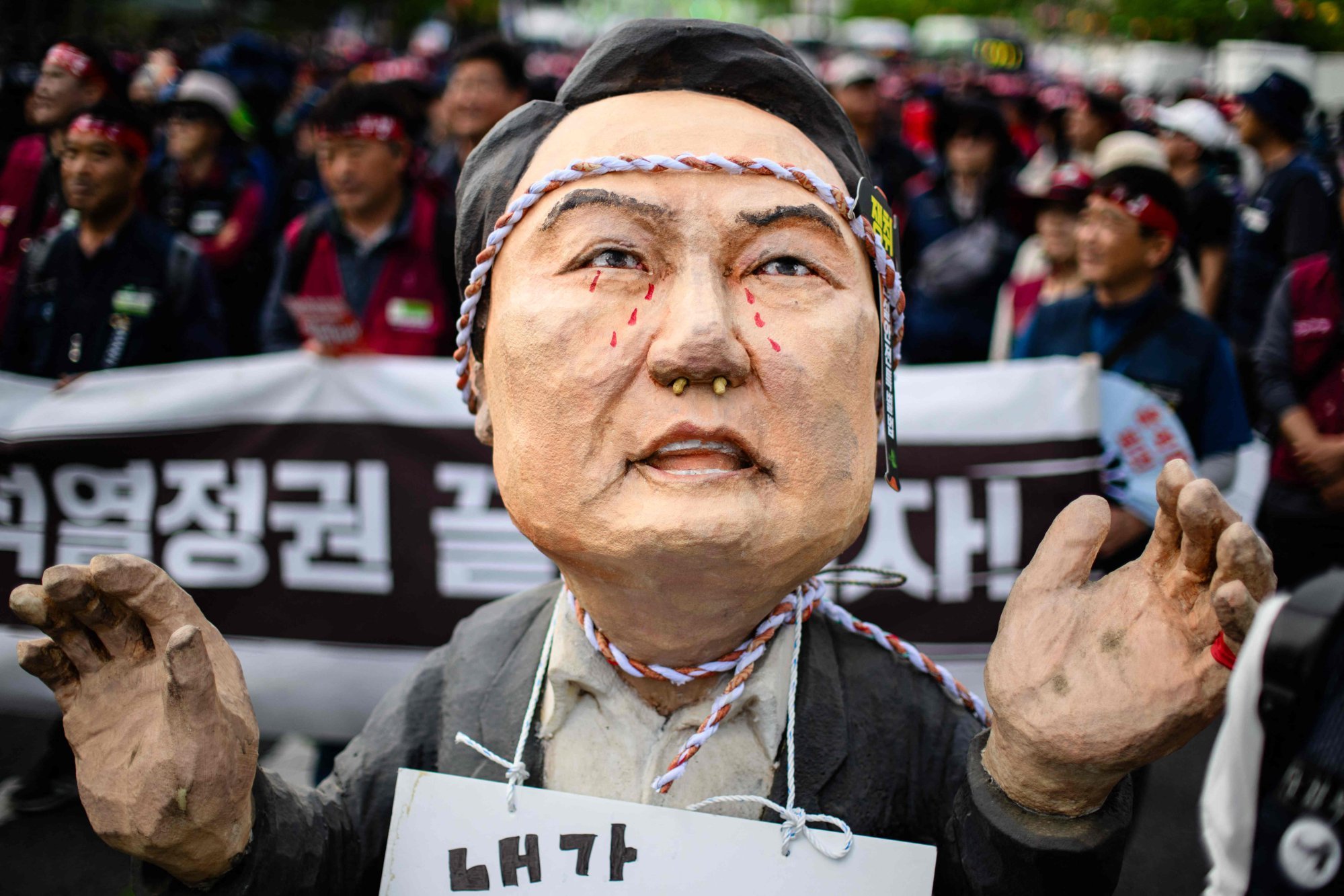 Trade union members march behind a prop depicting South Korean President Yoon Suk-yeol as they take part in a Labour Day rally in Seoul last week. Photo: AFP