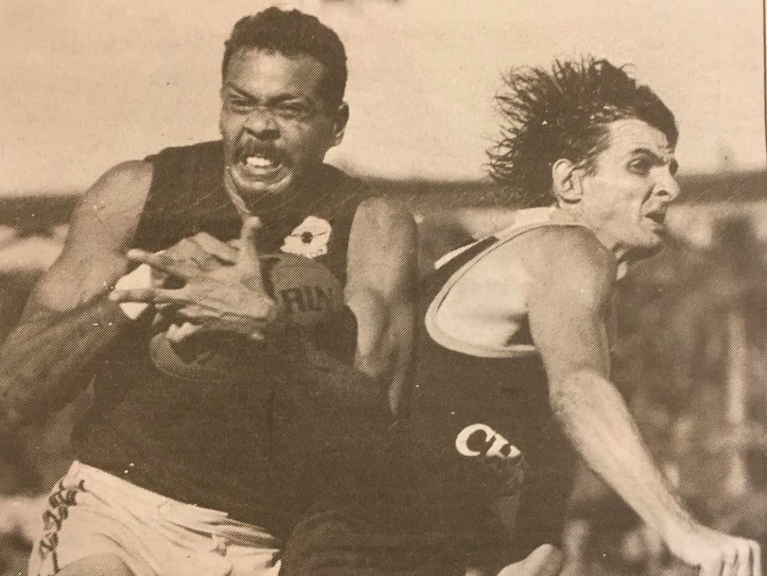 An old photo of Dennis Dunn taking a mark during his playing days.