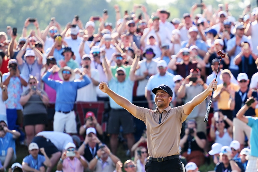 Xander Schaufelle holds his arms in the air