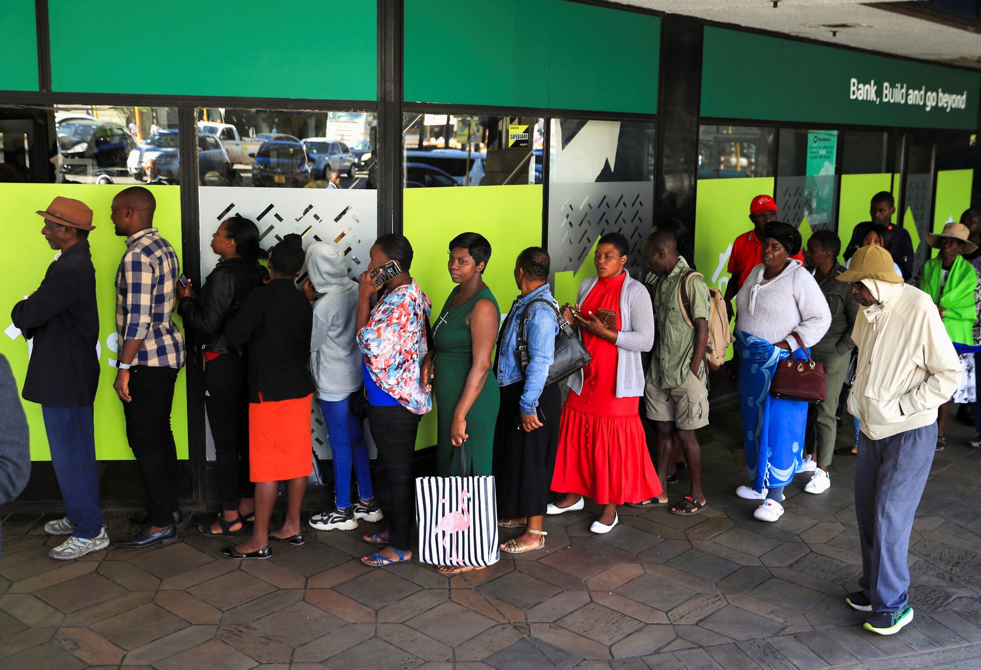 People queue to withdraw the new currency at a local bank in Harare, Zimbabwe. Photo: Reuters
