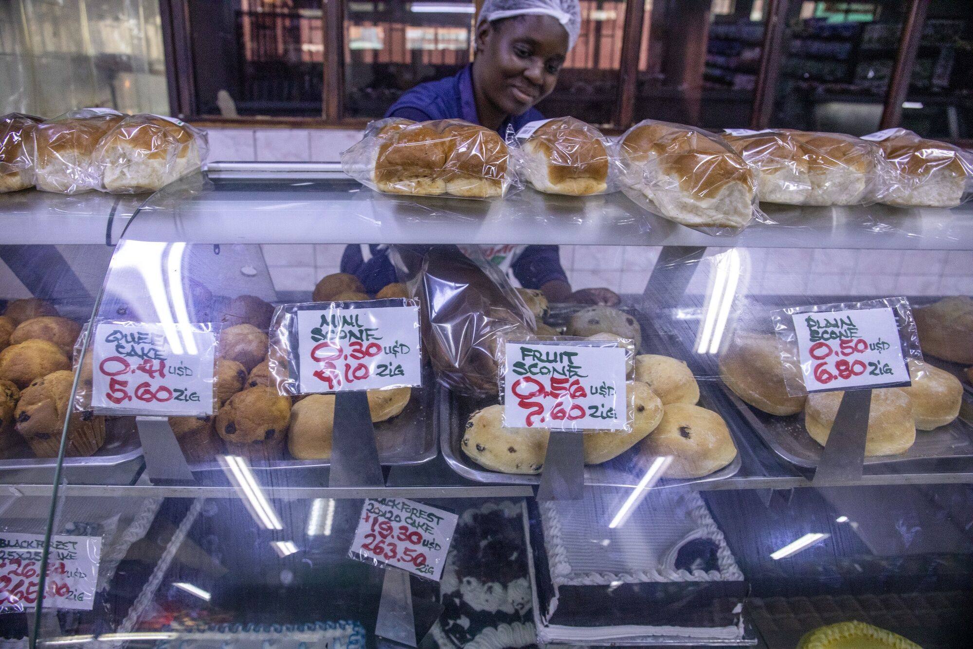 Price signs in the new ZiG currency and US dollar at a bakery counter in Harare, Zimbabwe. Photo: Bloomberg