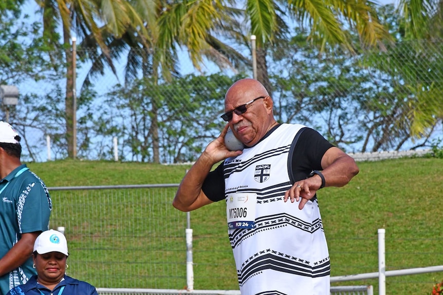 A man playing shot put. 