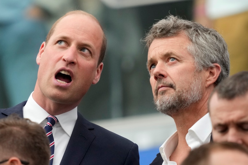 Britain's Prince William and Denmark's Frederik X talk in the crowd during an England-Denmark game at the European Championships