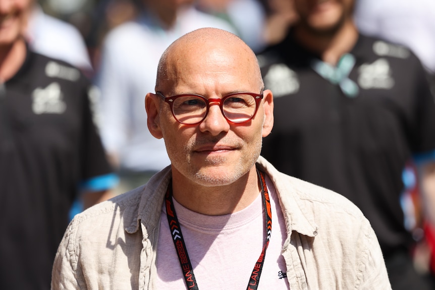 Jacques Villeneuve walks down a pitlane