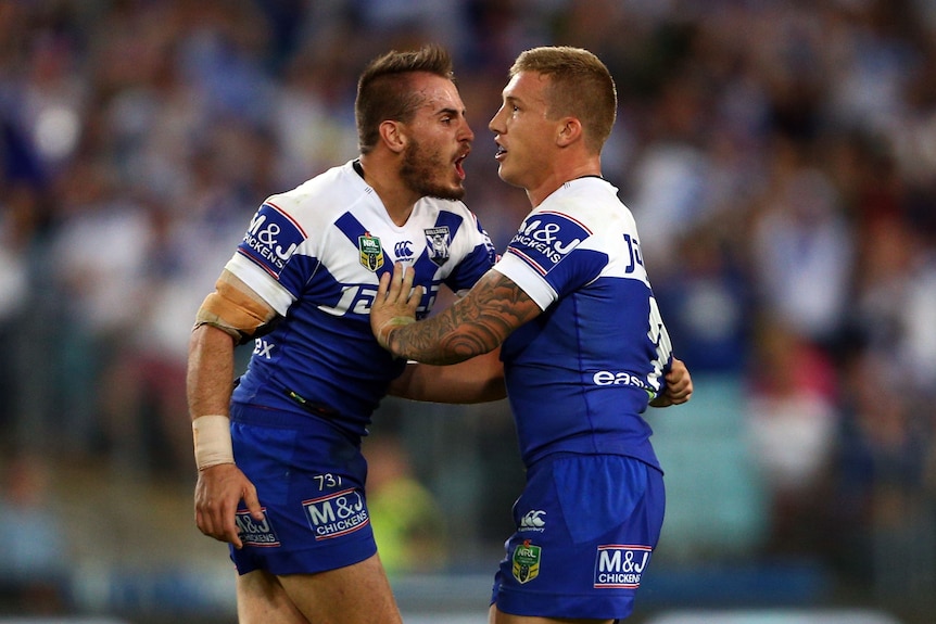 Two men celebrate after a field goal in a rugby league match