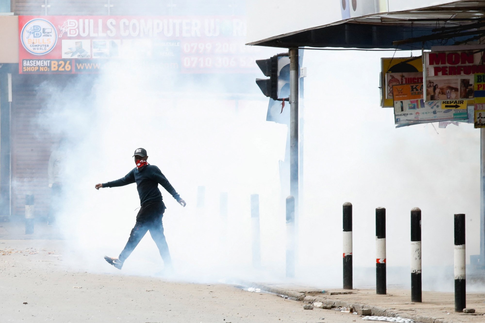A man walks through a tear gas cloud at a demonstration over police killings of people protesting against Kenya’s proposed finance bill in Nairobi, Kenya on Thursday. Photo: Reuters