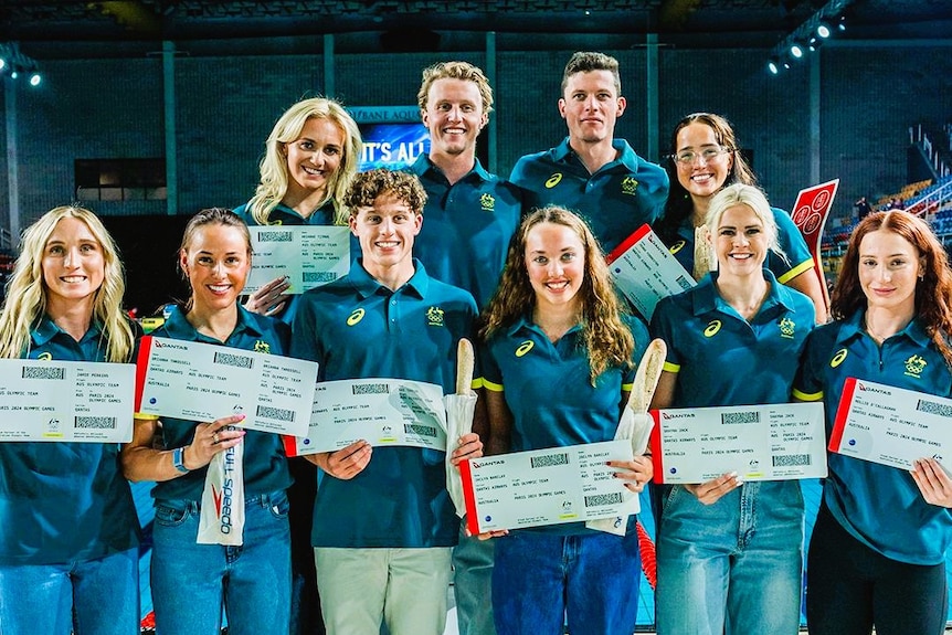A group of men and women holding plane tickets.
