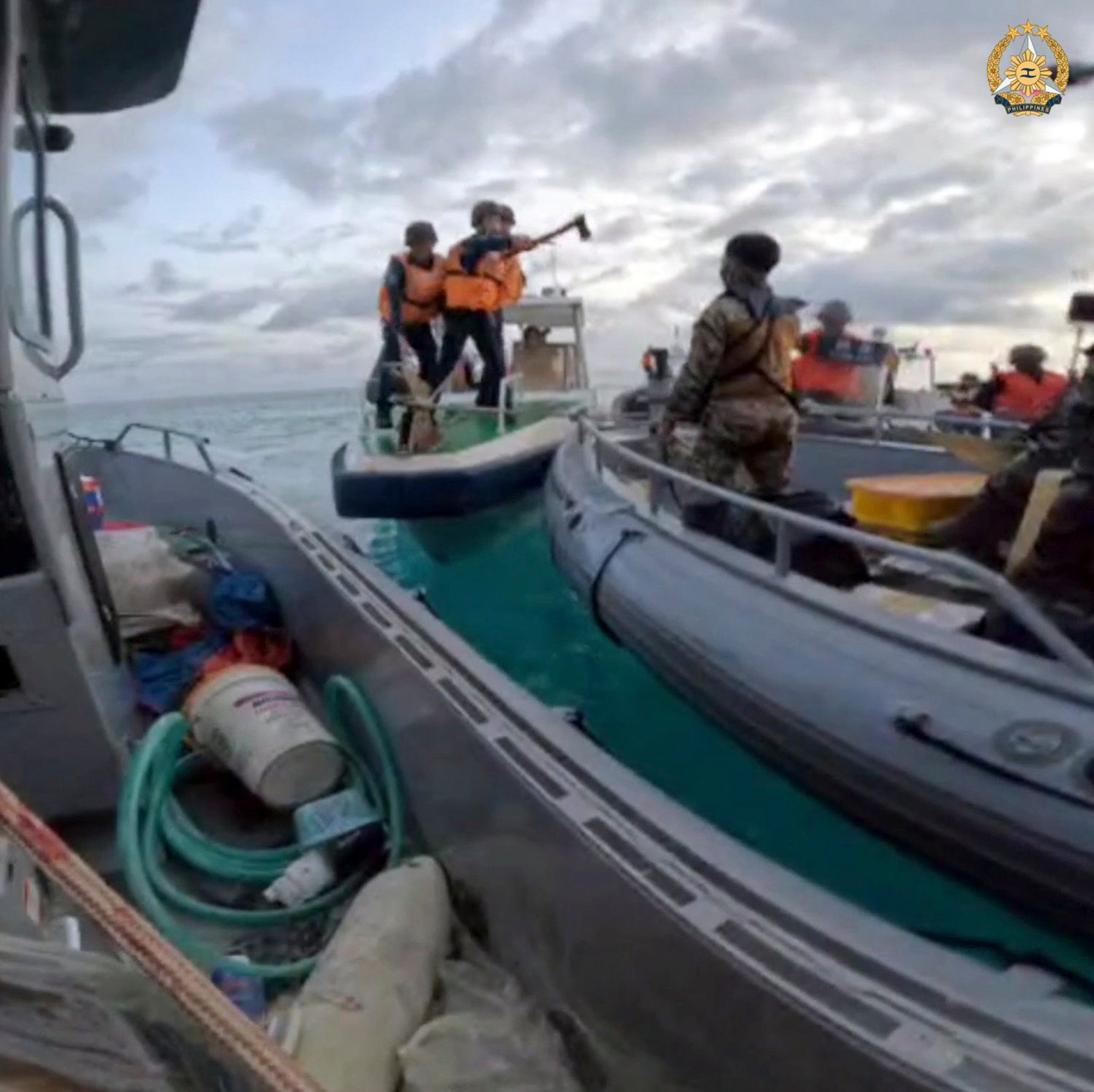 Chinese coastguard personnel hold an axe as they approach Philippine troops on a resupply mission in the Second Thomas Shoal at the disputed South China Sea on Monday. Photo: Armed Forces of the Philippines via AP