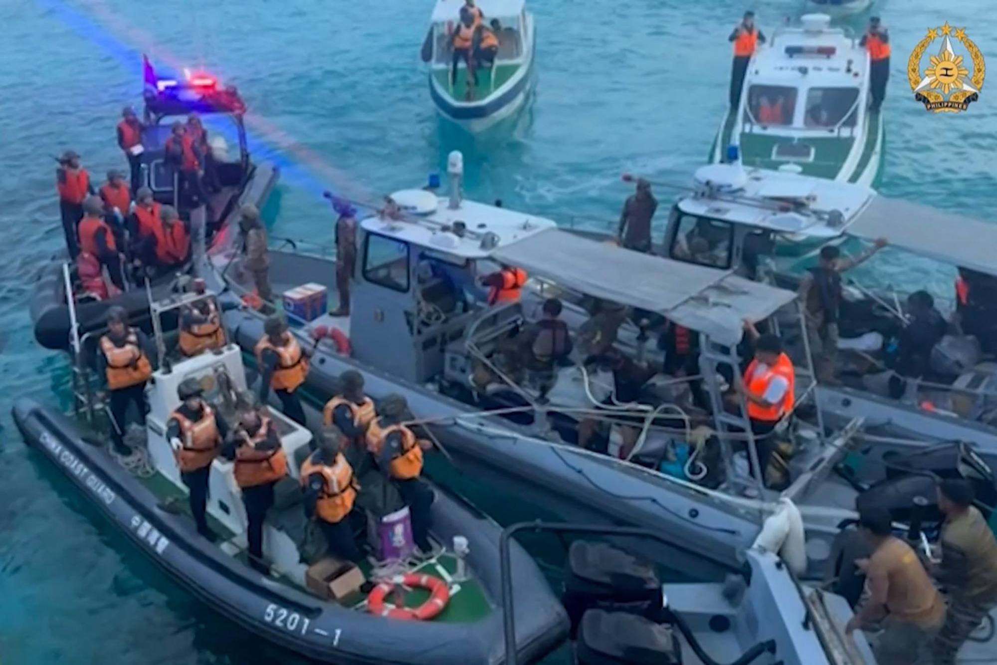 A video frame grab shows Chinese coastguard boats (left) approaching Philippine boats (centre) during an incident off Second Thomas Shoal in the South China Sea on Monday. Photo: Handout / Armed Forces of the Philippines Public Affairs Office