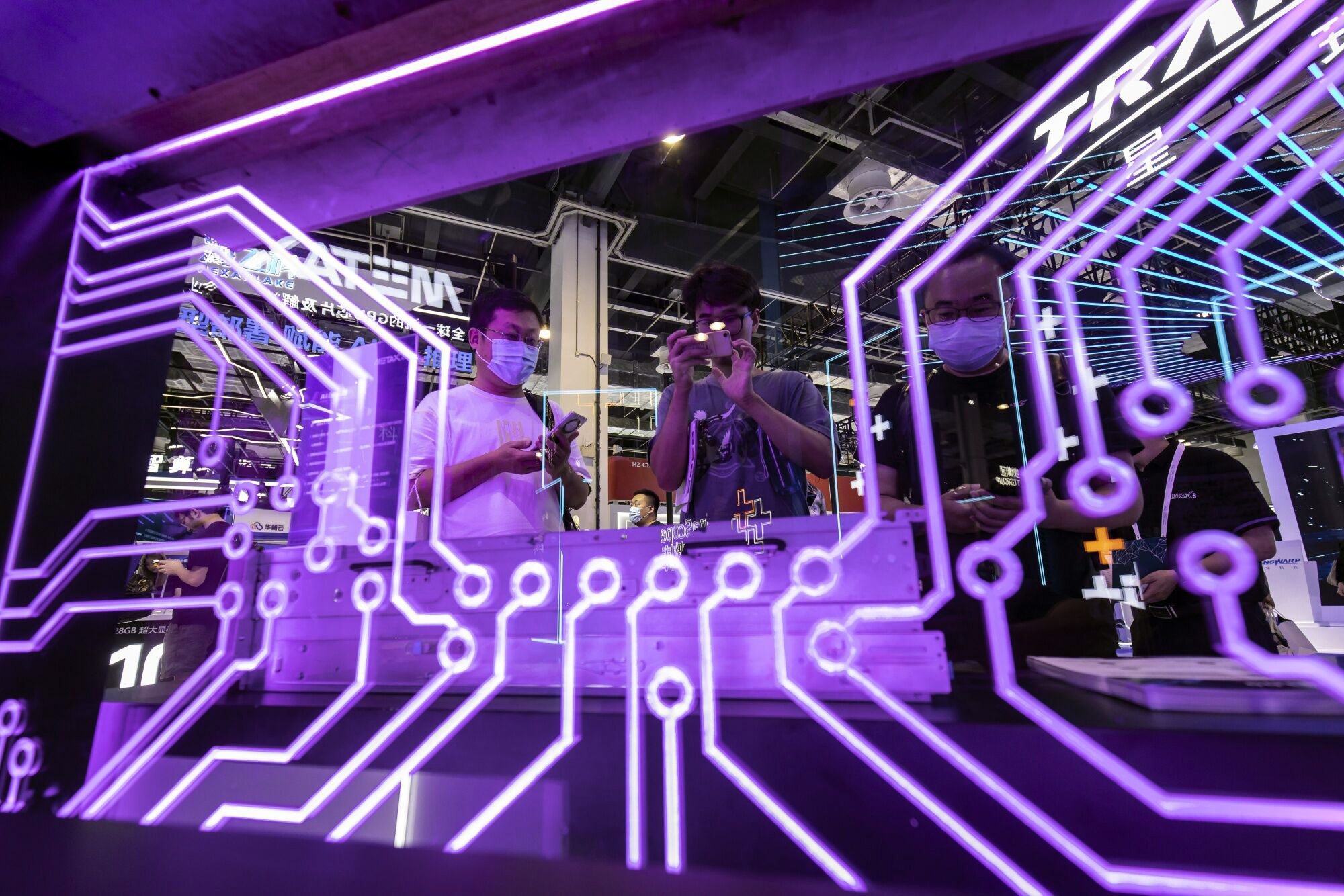 Attendees are seen at the MetaX booth during last year’s edition of the World Artificial Intelligence Conference in Shanghai. Photo: Bloomberg