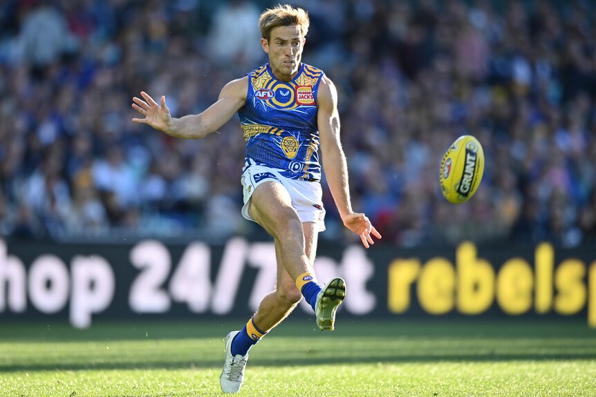 Brad Sheppard in a West Coast Eagles jumper kicking a football.