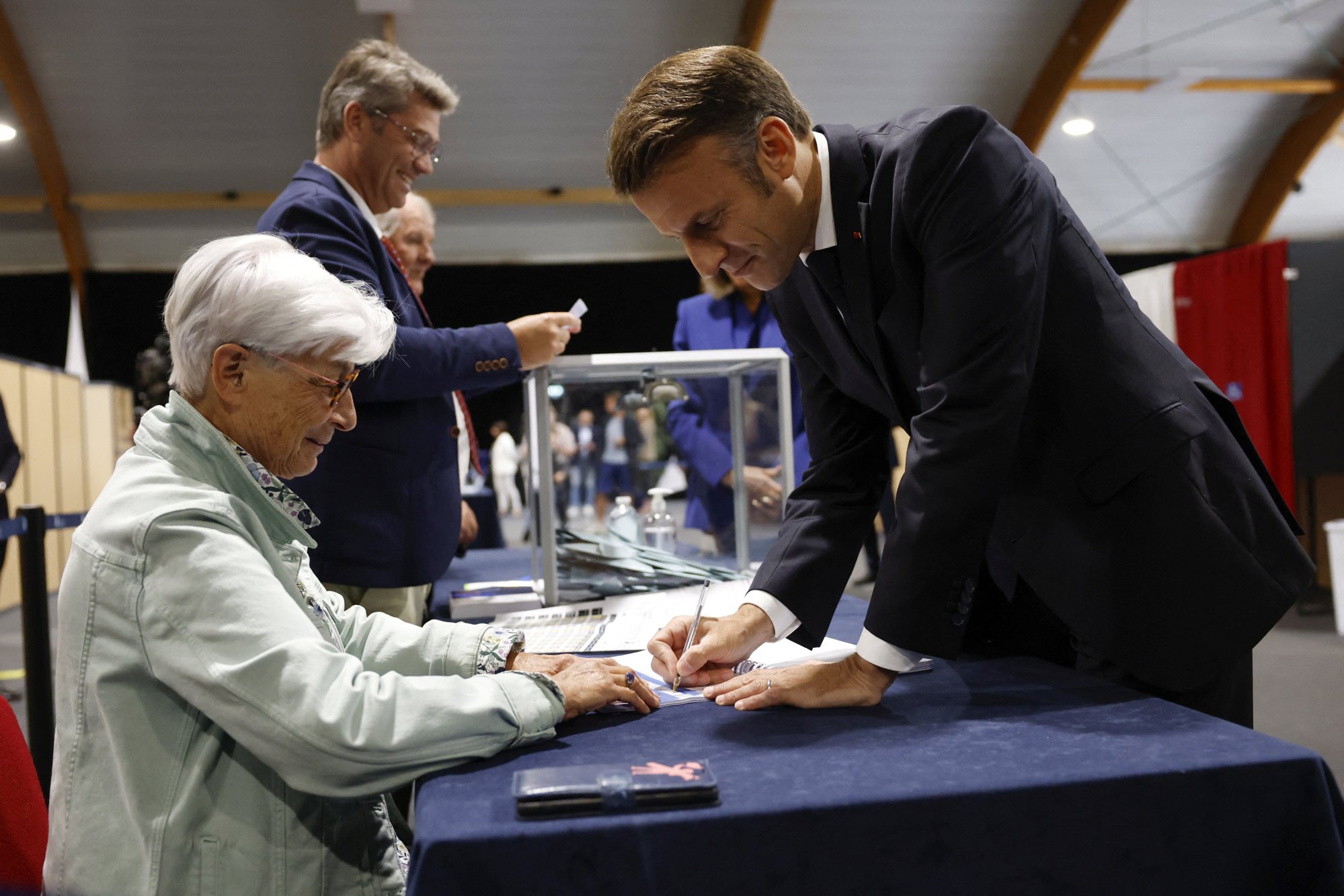 French President Emmanuel Macron (right) votes in the second round of French parliamentary elections at a polling station in Le Touquet-Paris-Plage, northern France, on Sunday. Photo: Pool via Reuters