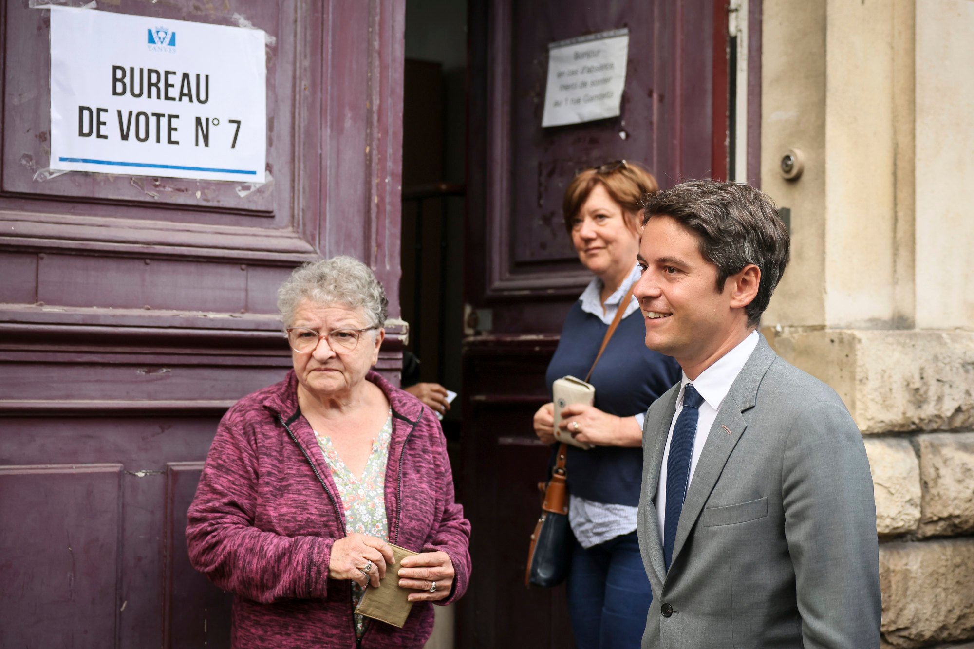 French Prime Minister Gabriel Attal (right) arrives to vote for the second round of the legislative election on Sunday in Vanves, outside Paris. Photo: AP
