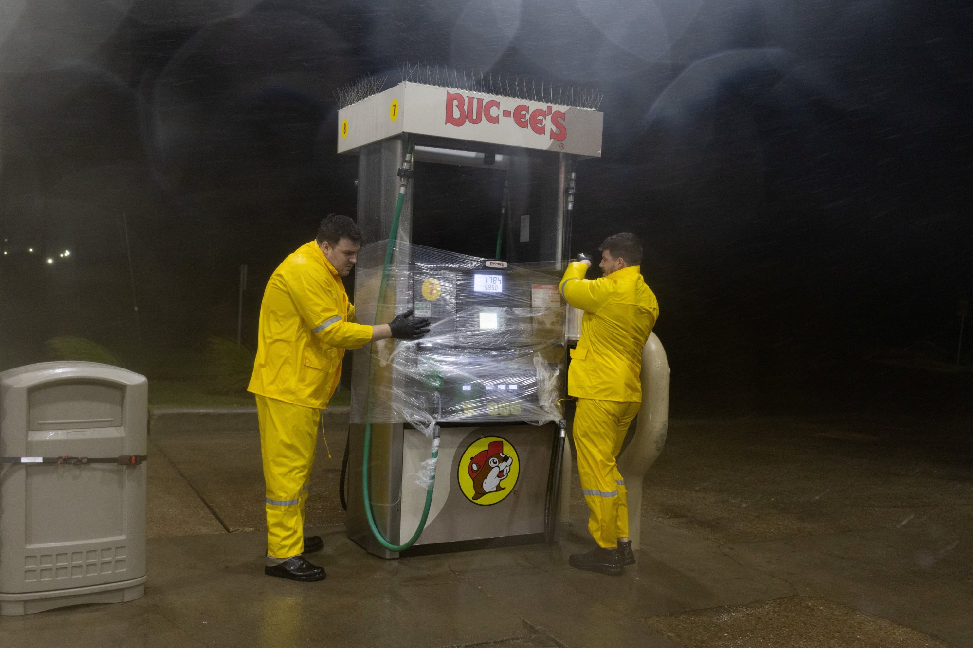 Employees at a fuelling station wrap plastic around a fuel pump to protect it from wind and rain due to Hurricane Beryl in Freeport, Texas on Monday. Photo: Reuters