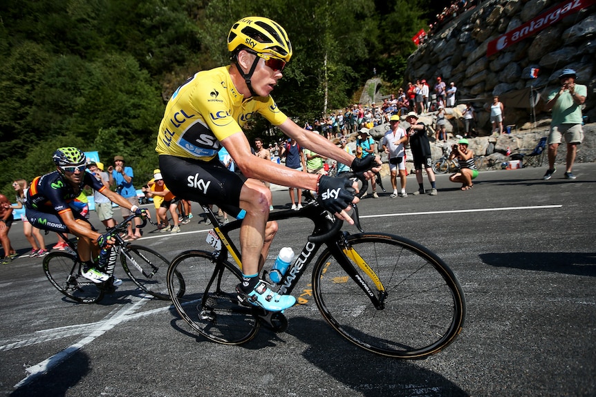 Chris Froome rides uphill in the yellow jersey