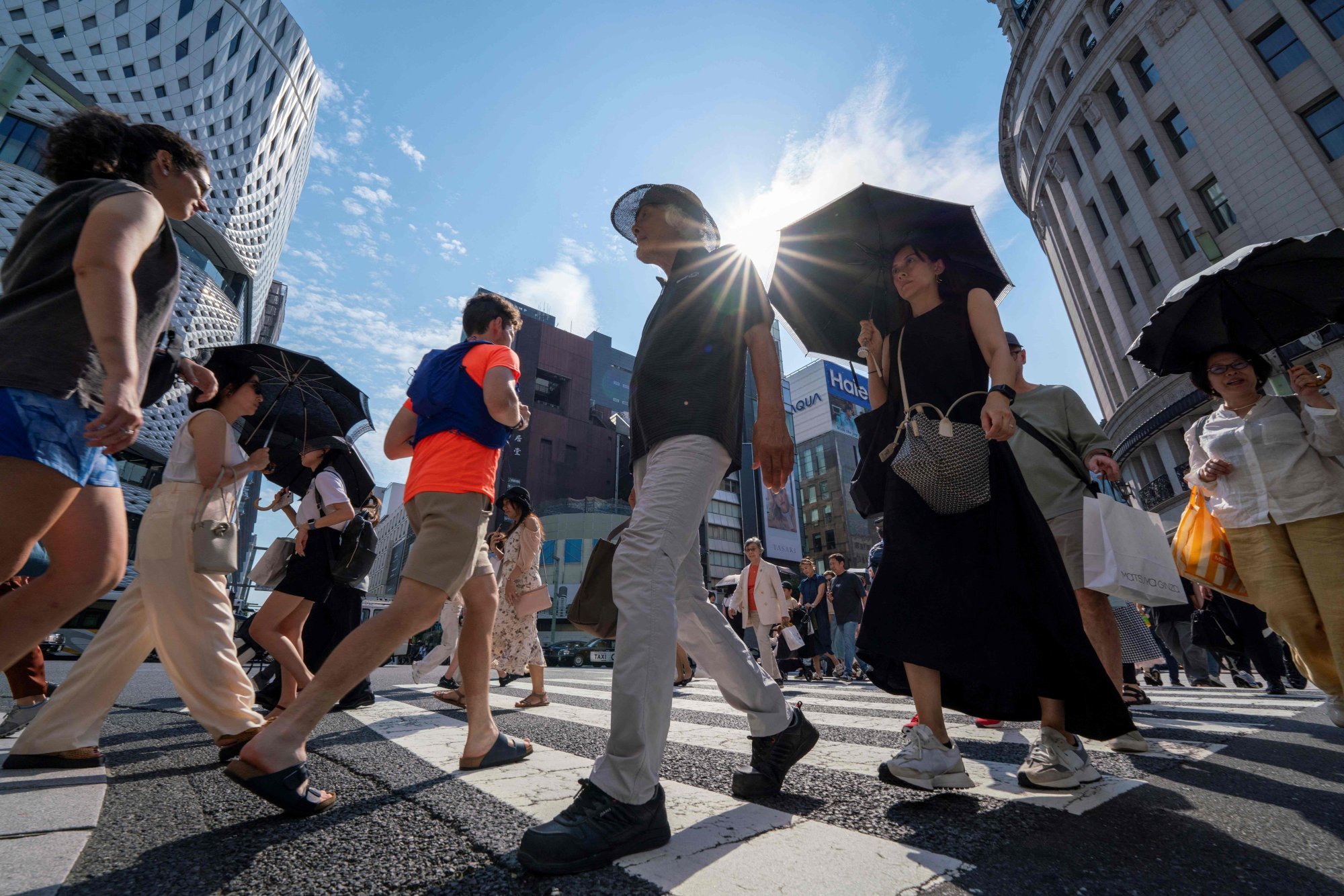 Pedestrians walk on a crossing in central Tokyo, where temperatures topped 35 degrees on Monday. Photo: AFP