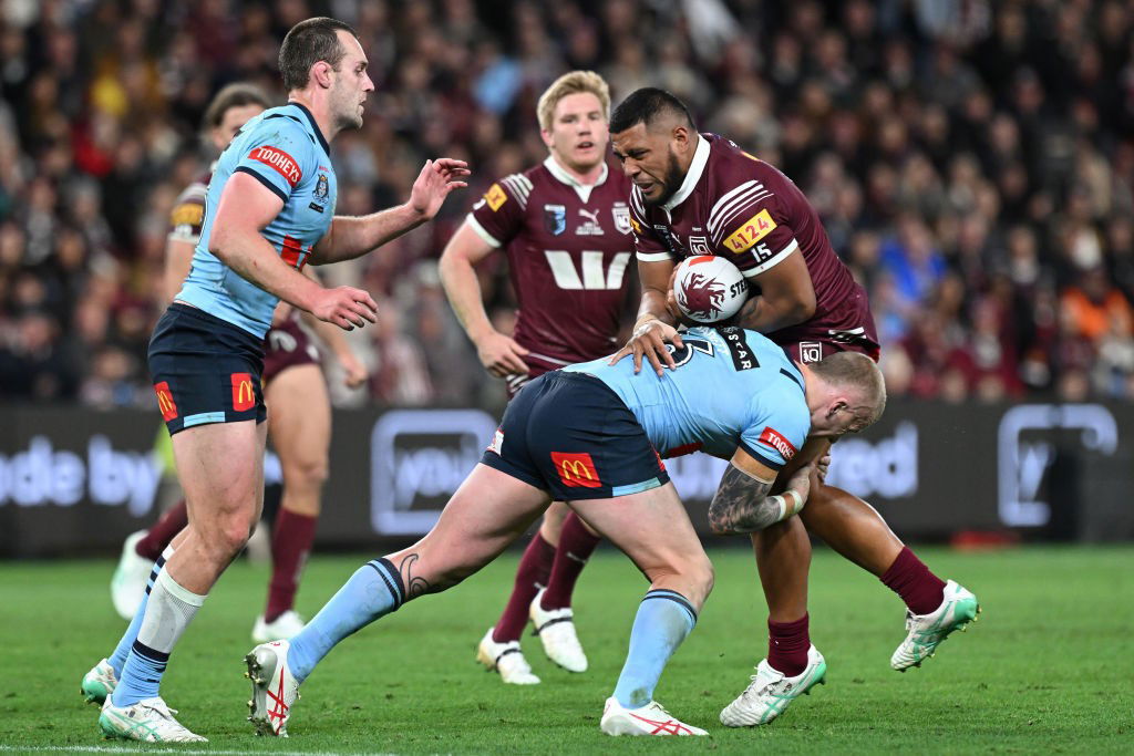 NSW forward Mitch Barnett tackles Queensland's Moeaki Fotuaika in State of Origin III.