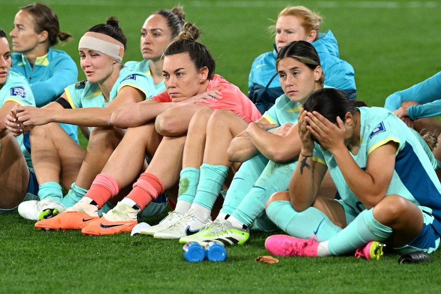 Sam Kerr grabs her head after the Matildas' World Cp loss to Sweden.
