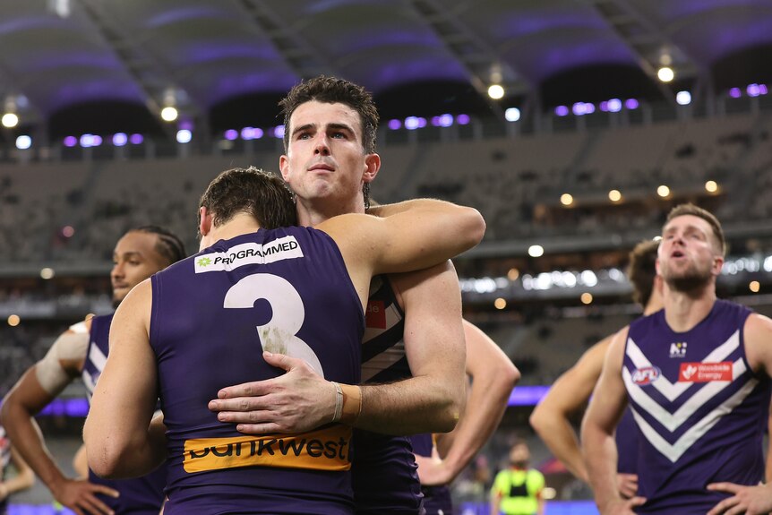 Andrew Brayshaw shares a hug with Caleb Serong