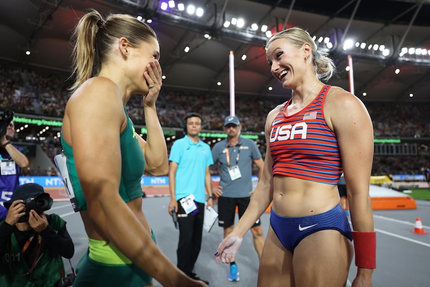 Nina Kennedy covers her mouth as Katie Moon smiles
