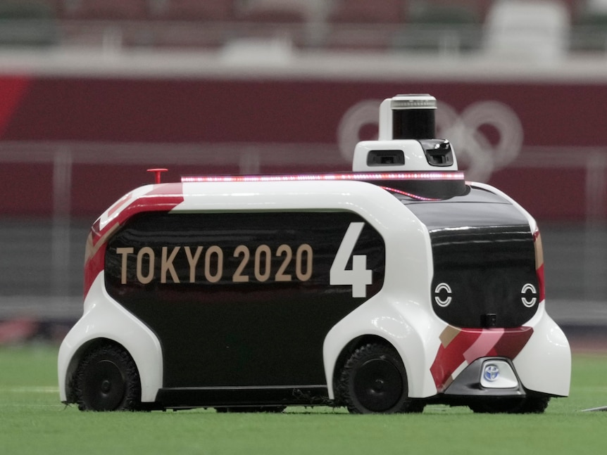 An RC that resembles a futuristic bus moves across grass