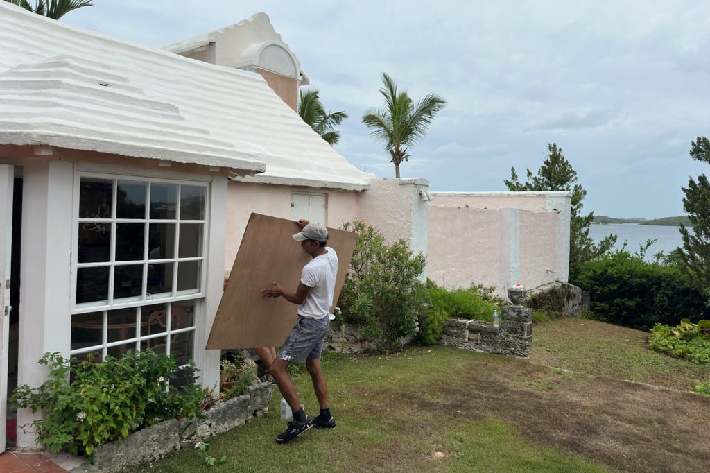 A man boards up a house to protect it from the approaching Hurricane Ernesto in Warwick, Bermuda, on Friday ahead of Hurricane Ernesto’s arrival. Photo: Reuters