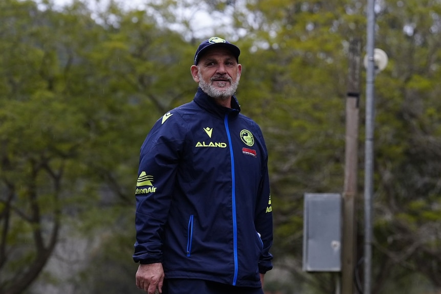 A man coaches a women's rugby league team